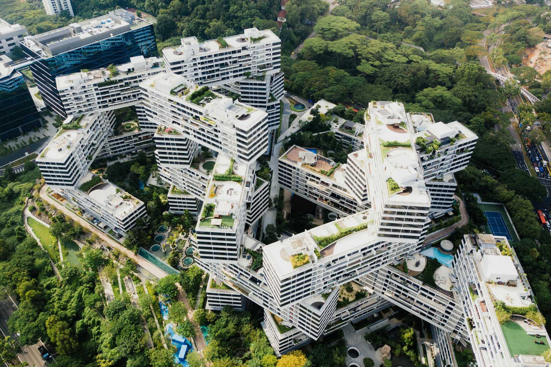 Aerial image of a building nestled in a park.