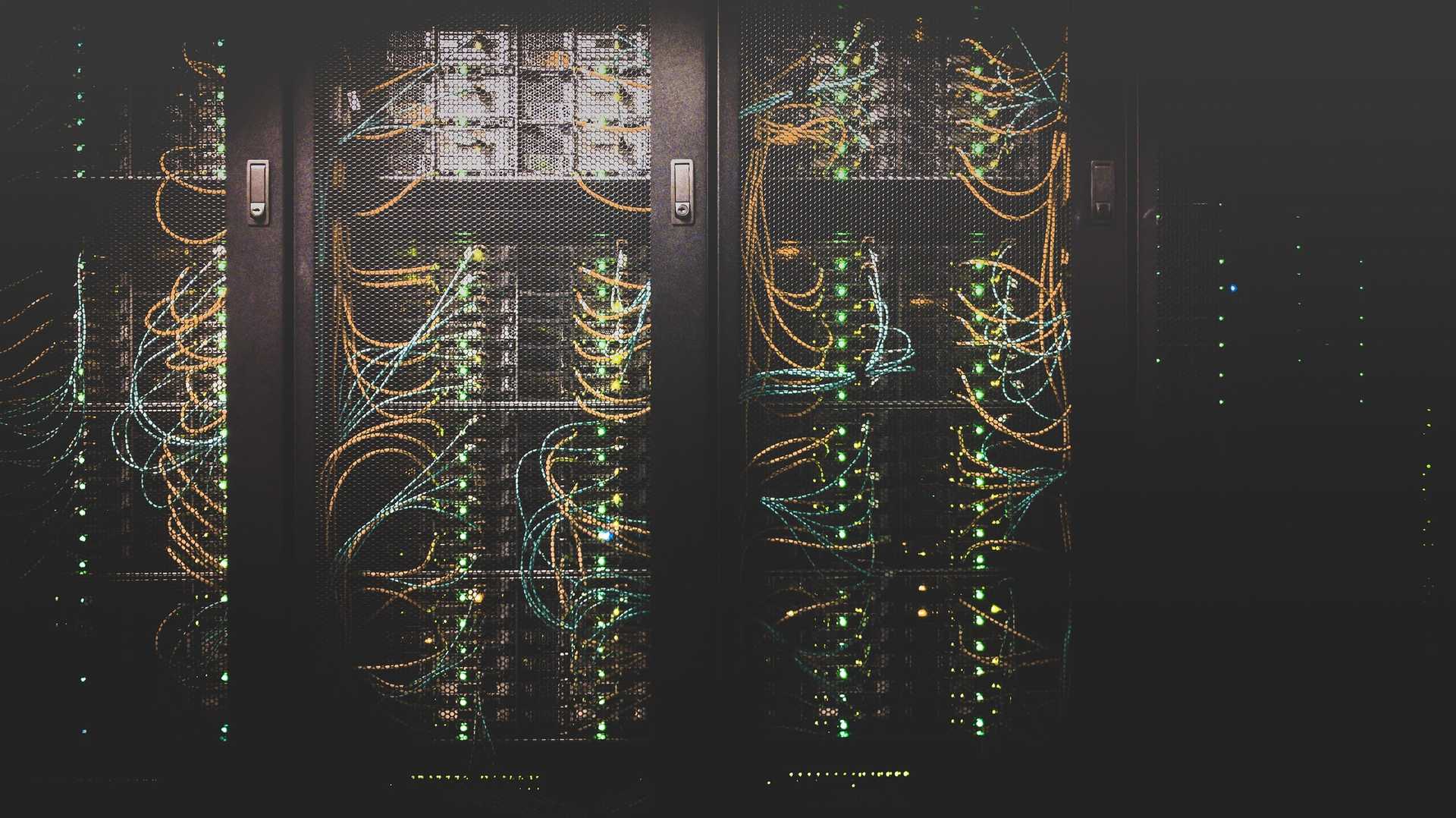 Wires connect server racks in a data center.