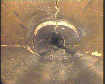 A view down the inside of a cracked water main pipe.