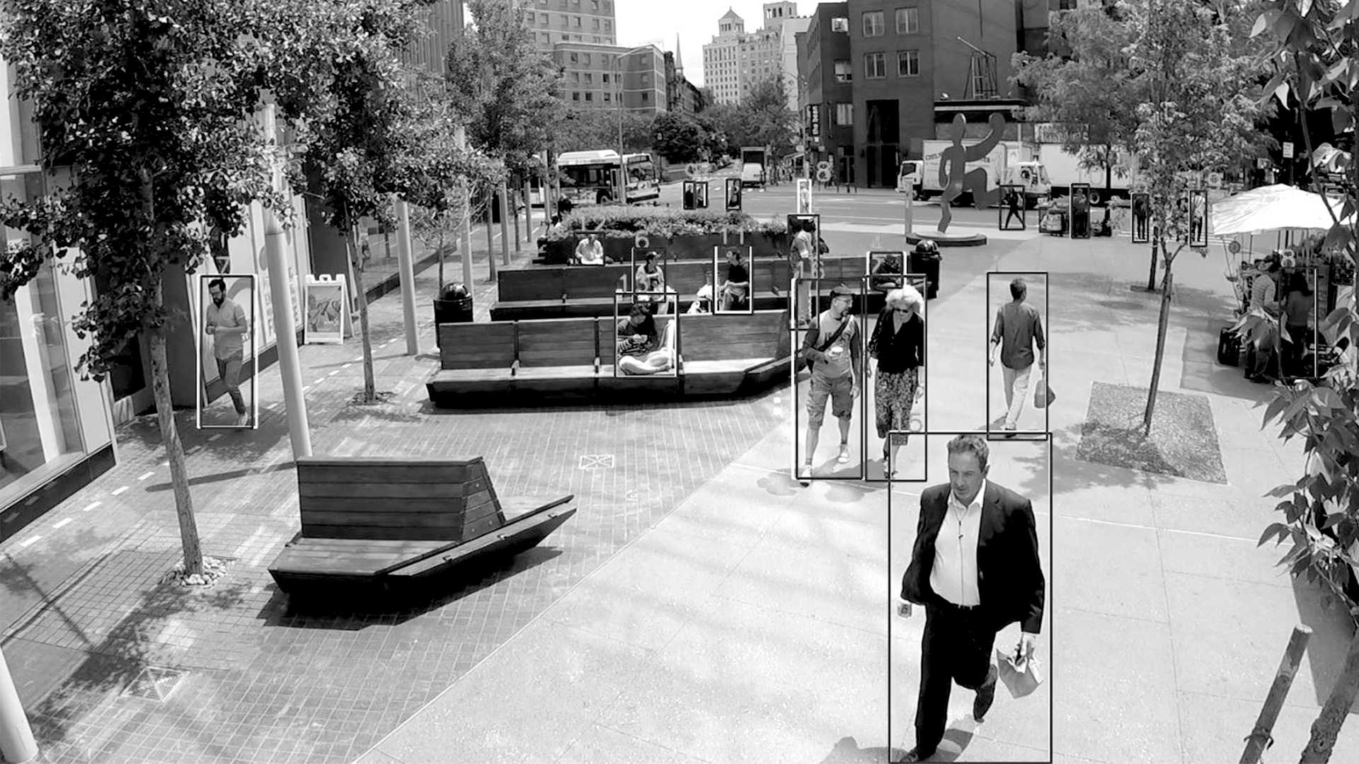 Black and white image of an urban plaza with computer vision object identification overlays.