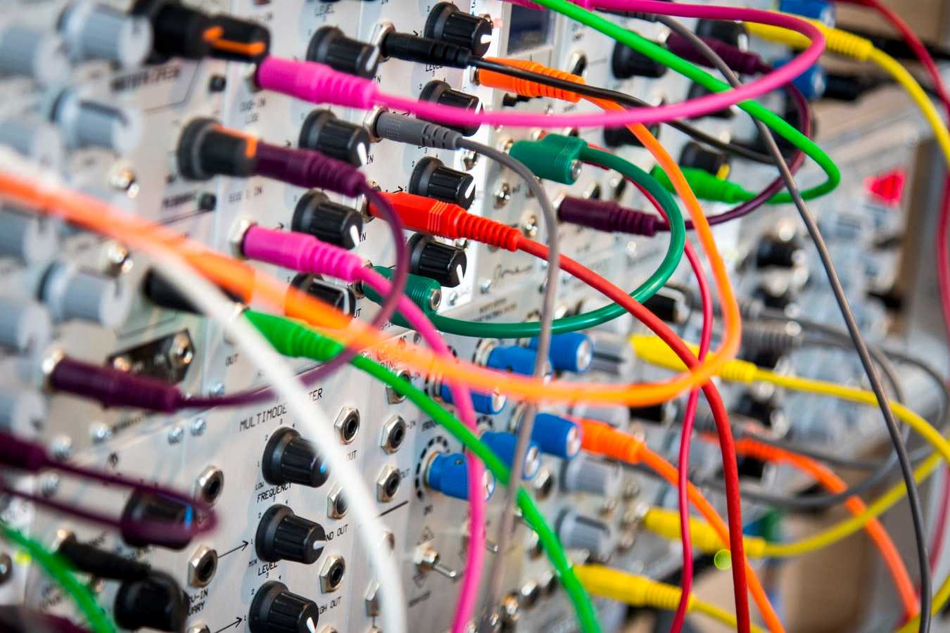 Colored wires plug into an audio device.