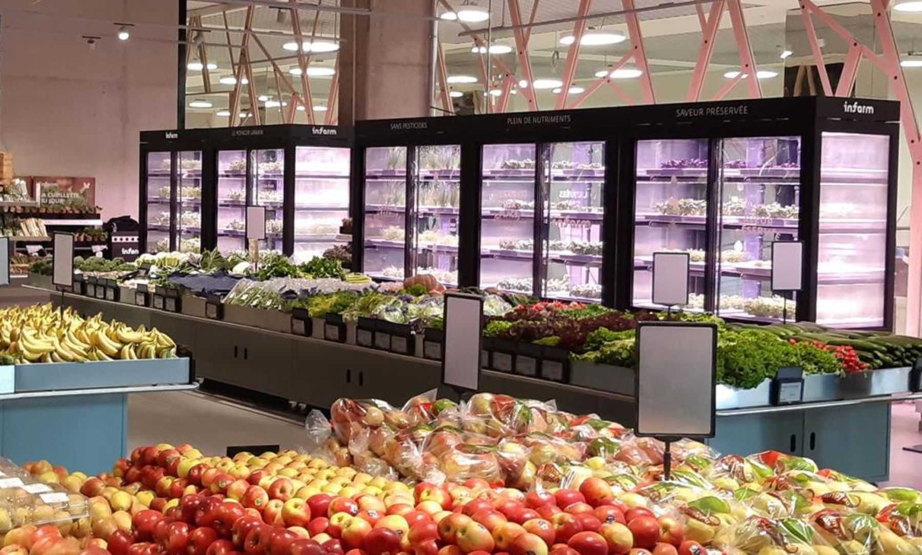 Indoor vertical farm cabinets sit alongside retail food displays.
