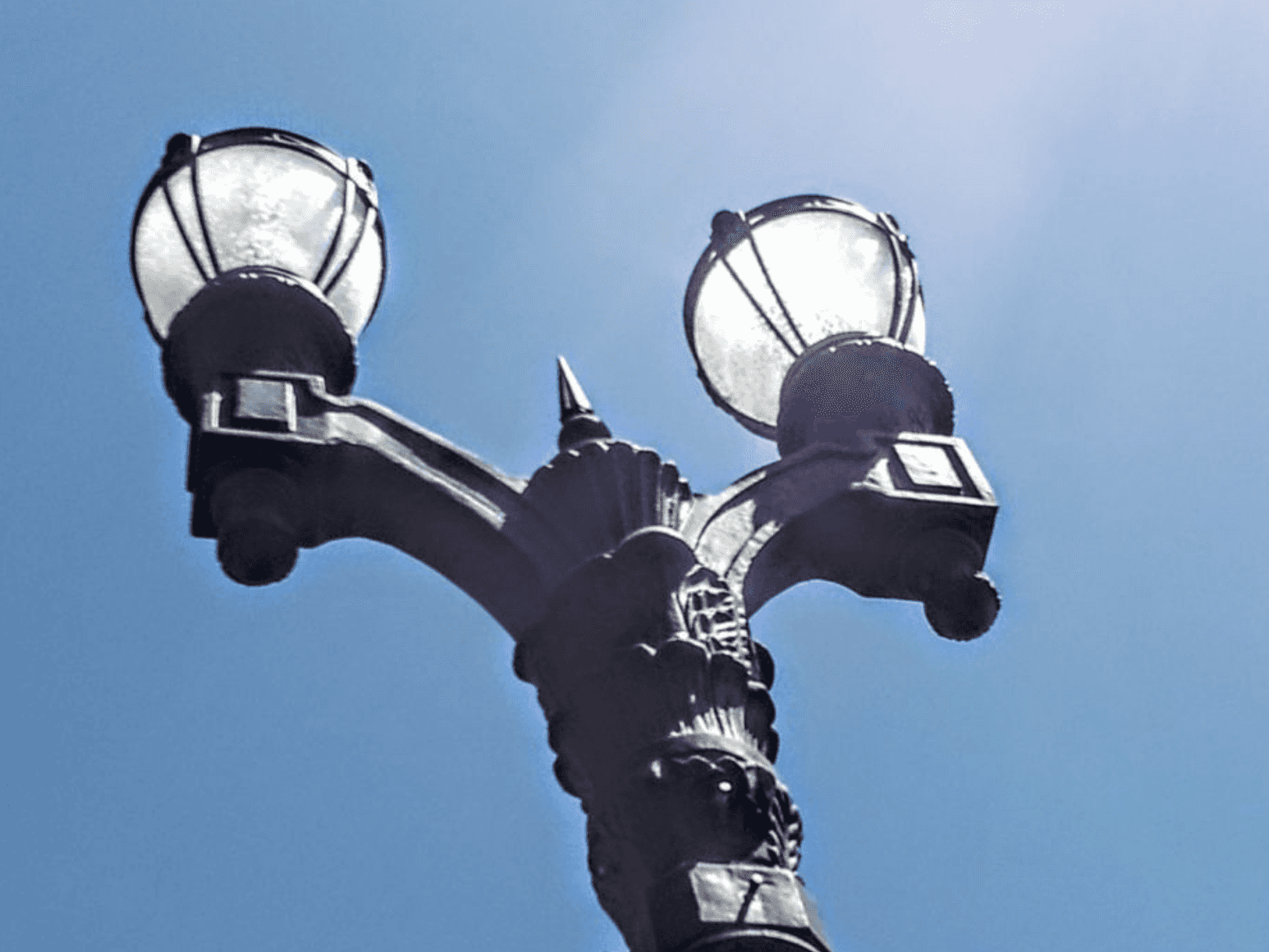 A historic replica streetlight with cameras mounted underneath.