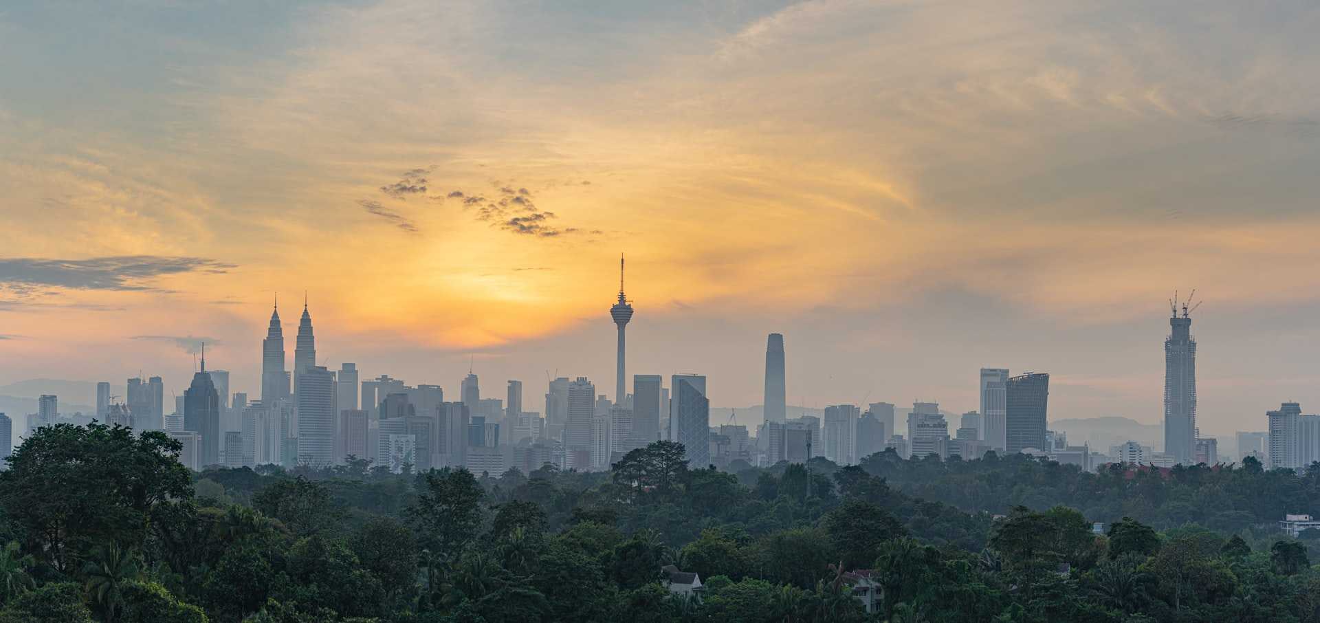The skyline of Kuala Lumpur at dawn.