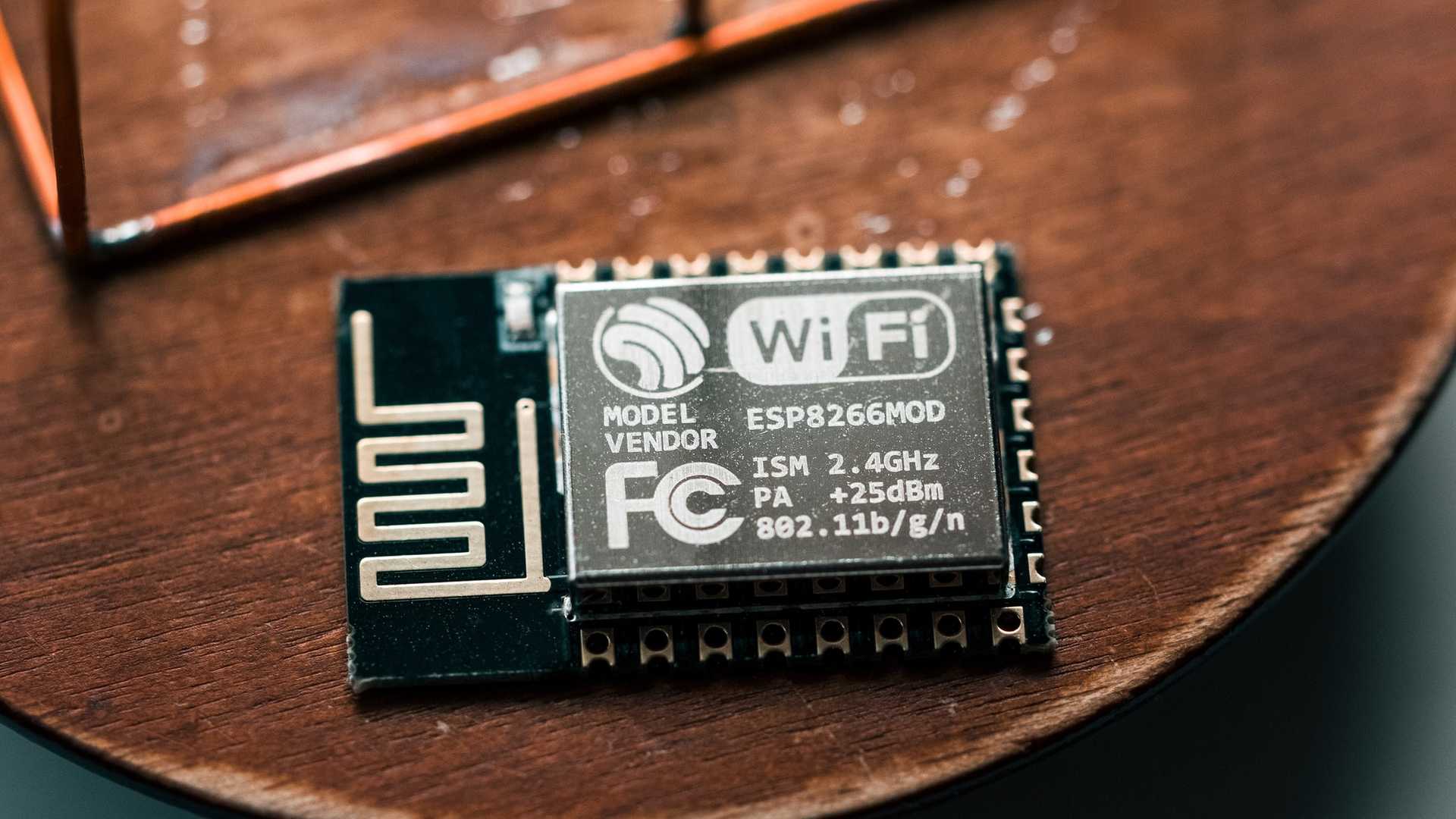 Closeup of a low-cost Wifi chip on a wooden table.