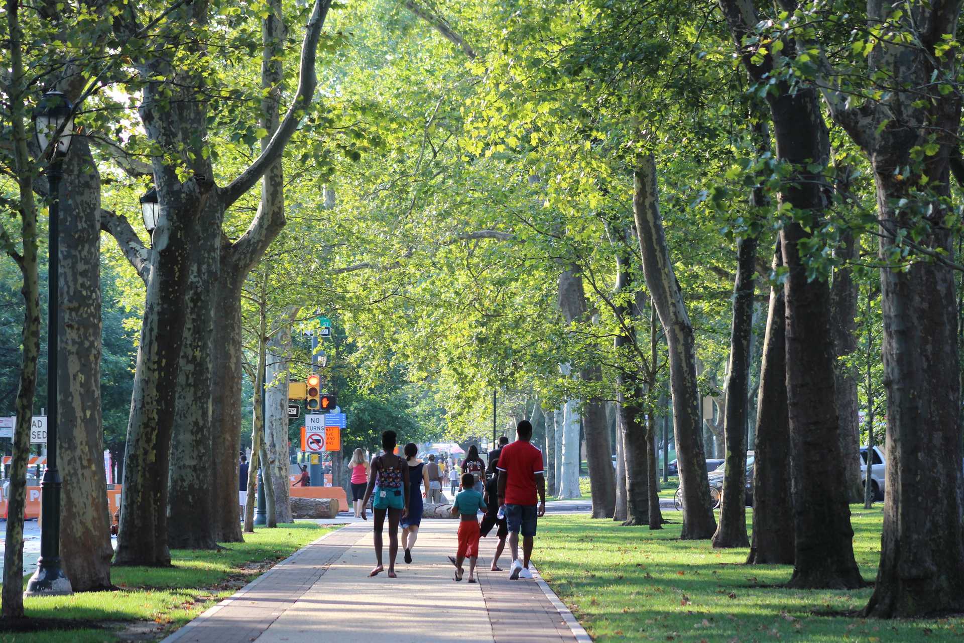 Children walk down a tree-lined promenade in Philadelphia.