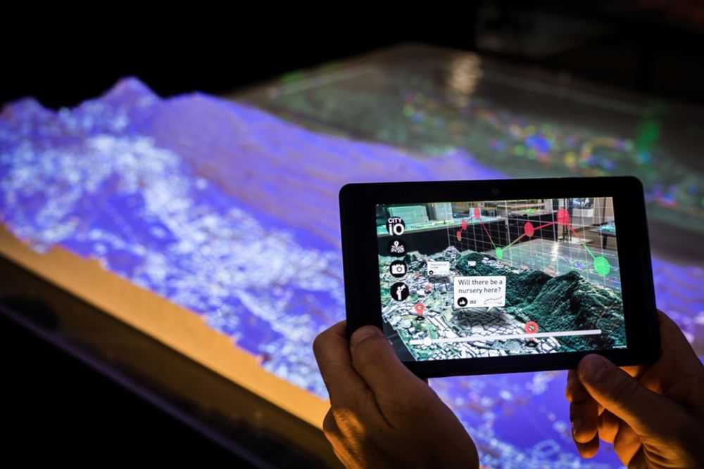 A tablet superimposes information on a view of a 3D printed model of the nation of Andorra.