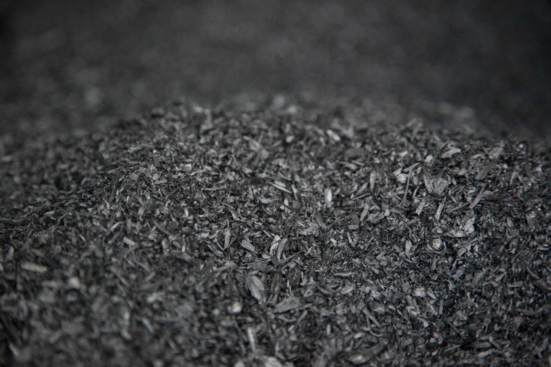 A pile of black pellets of biochar.