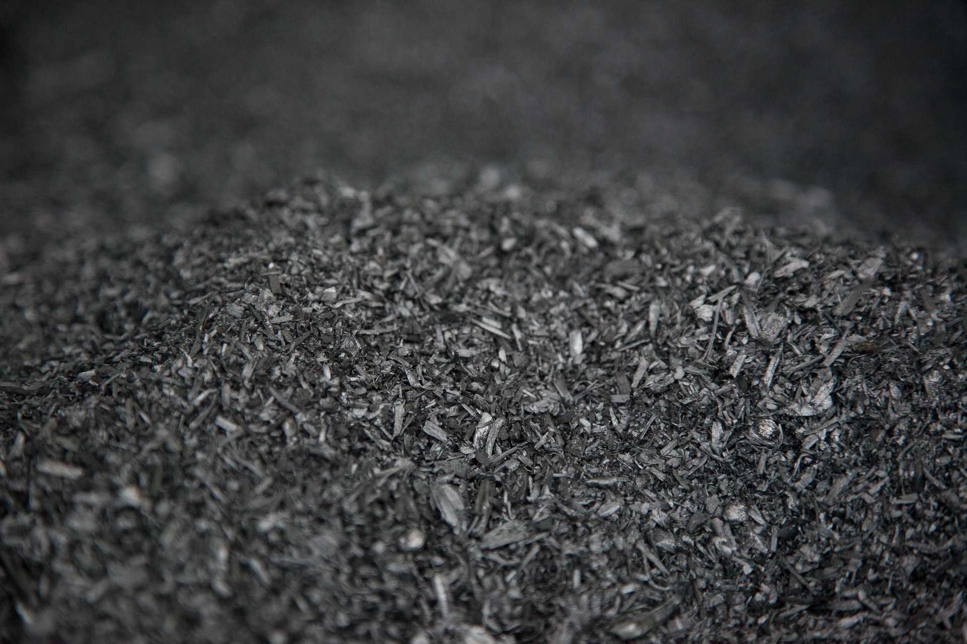 A pile of black biochar chips.