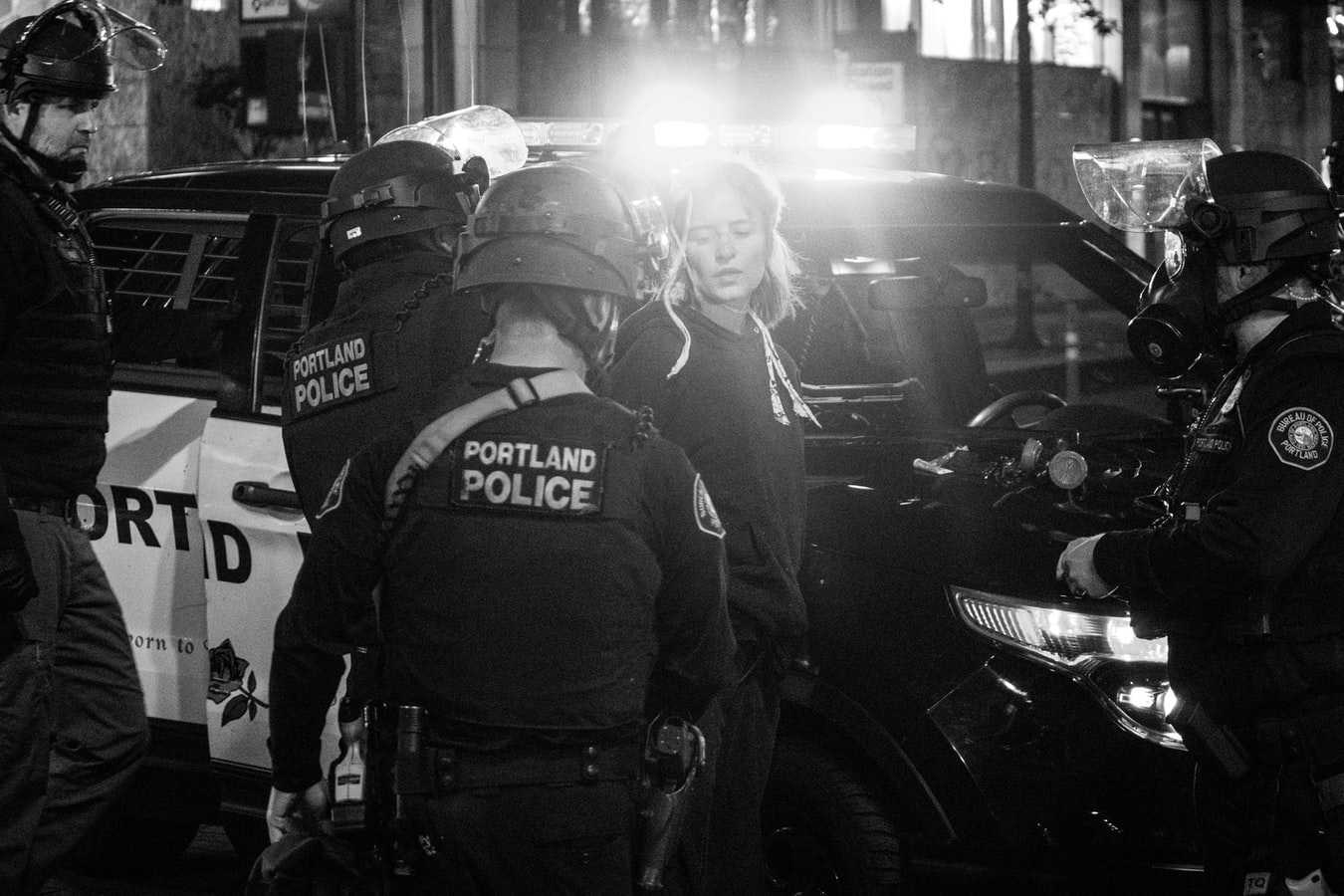 Police in Portland, Oregon arrest a young white woman.
