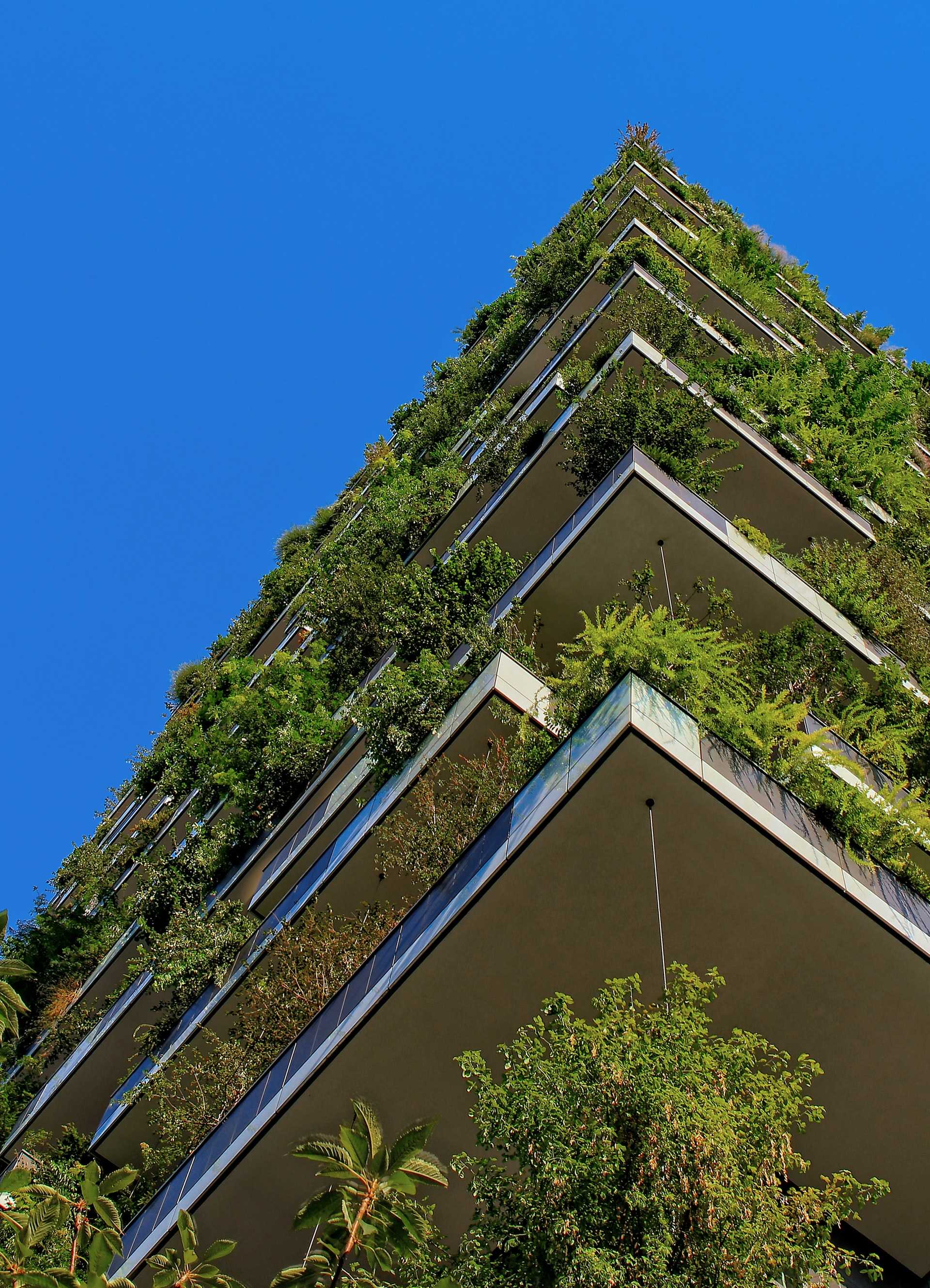 A high-rise building with plantings spilling down from balconies.